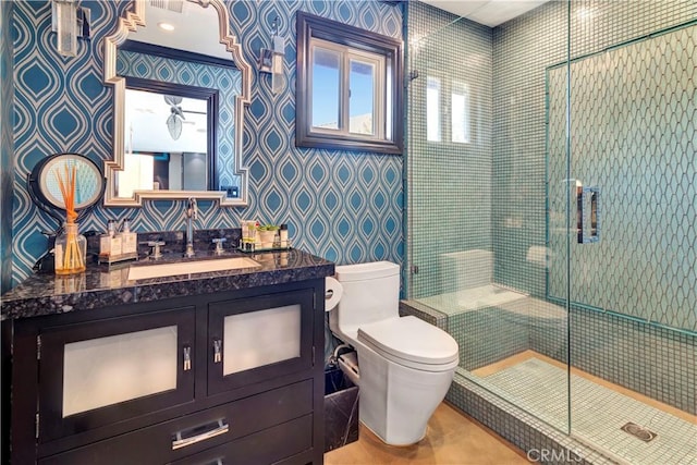 bathroom featuring vanity, toilet, and a shower with door