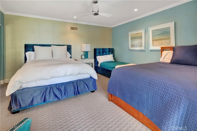 carpeted bedroom with ceiling fan and ornamental molding