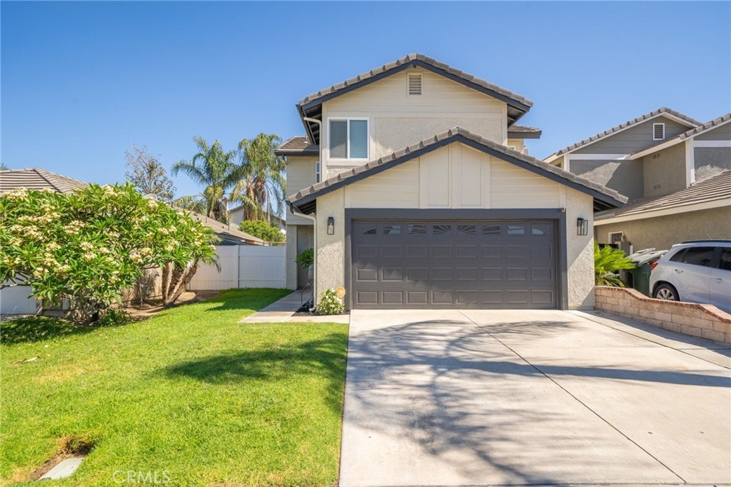 front of property featuring a garage and a front lawn