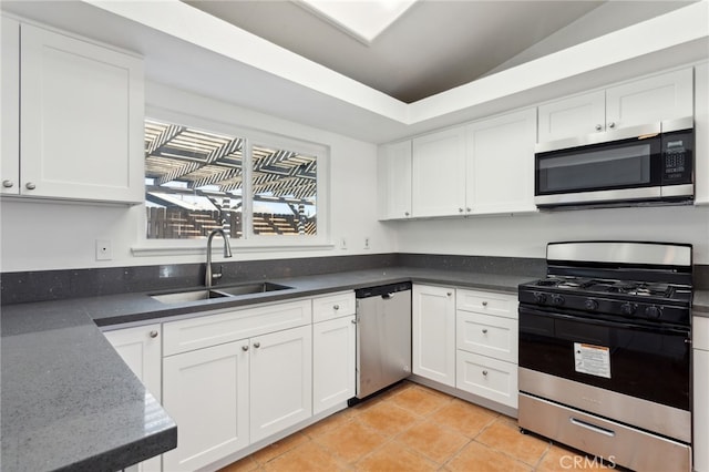 kitchen with white cabinetry, light tile patterned flooring, appliances with stainless steel finishes, and sink