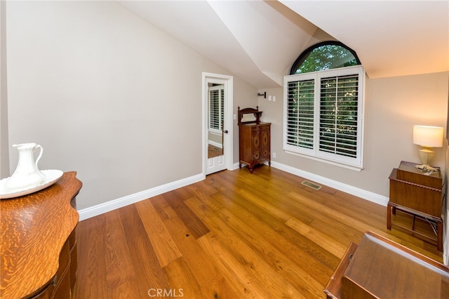 interior space featuring lofted ceiling and hardwood / wood-style floors