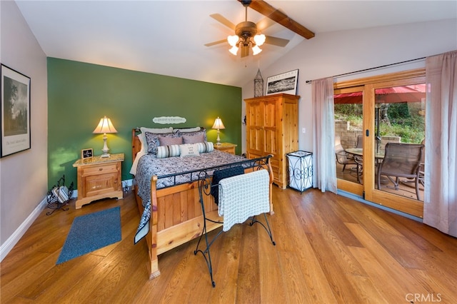 bedroom featuring light hardwood / wood-style flooring, ceiling fan, lofted ceiling with beams, and access to exterior