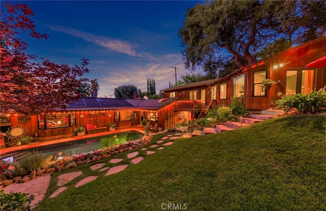 yard at dusk featuring a patio area