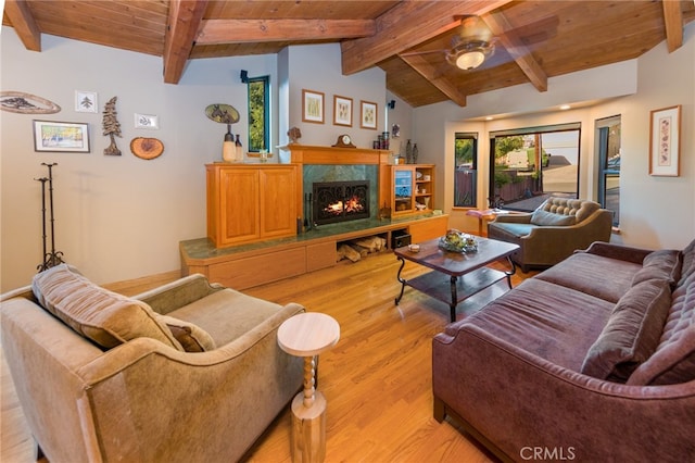 living room featuring wood ceiling, light wood-type flooring, vaulted ceiling with beams, and a premium fireplace