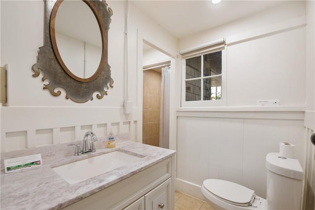 bathroom with tile patterned floors, vanity, curtained shower, and toilet