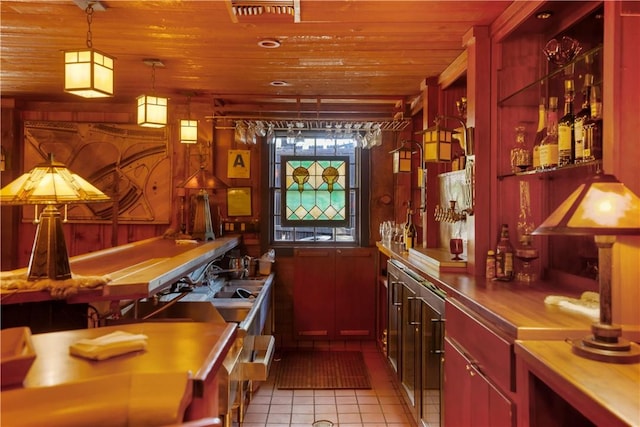 bar with wooden walls, light tile patterned floors, wood ceiling, and decorative light fixtures