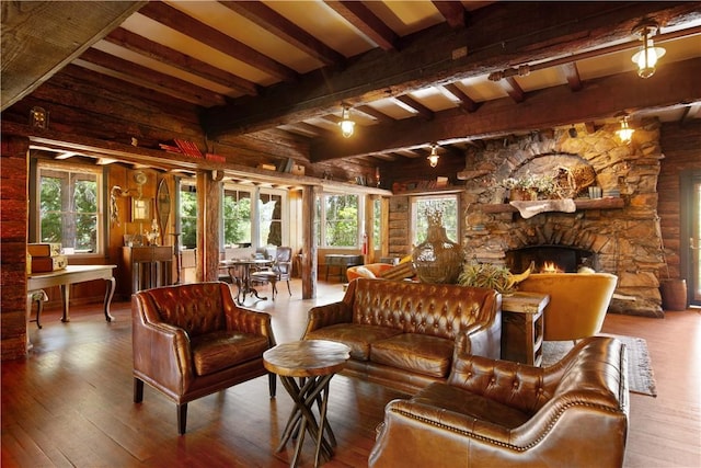 interior space with beamed ceiling, hardwood / wood-style flooring, and a fireplace