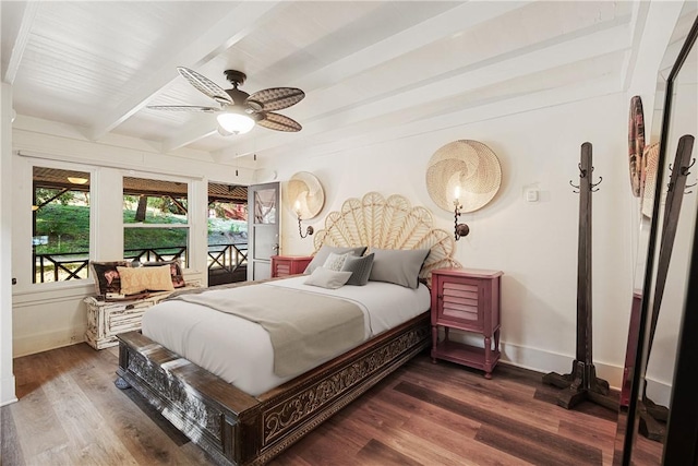 bedroom with ceiling fan, beamed ceiling, and dark wood-type flooring