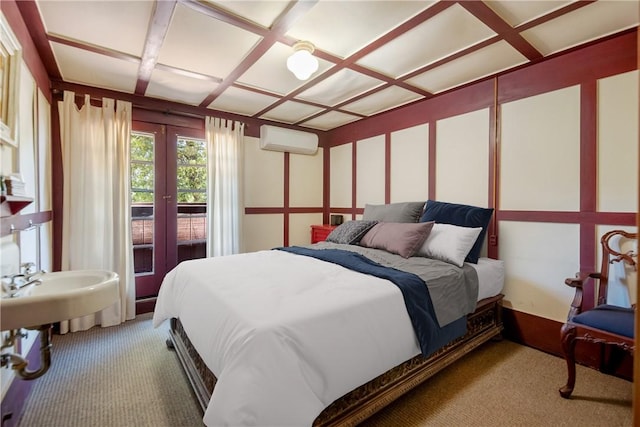 bedroom with carpet flooring, coffered ceiling, and a wall mounted air conditioner