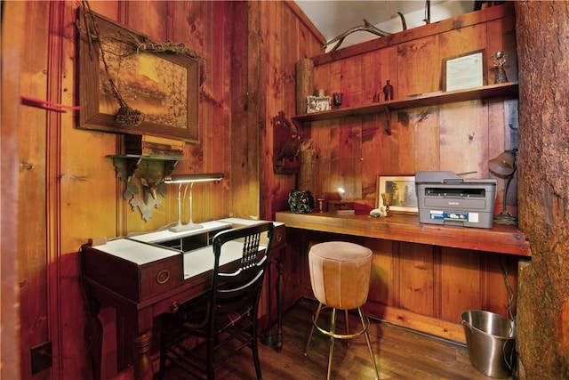 bar featuring dark hardwood / wood-style flooring and wood walls