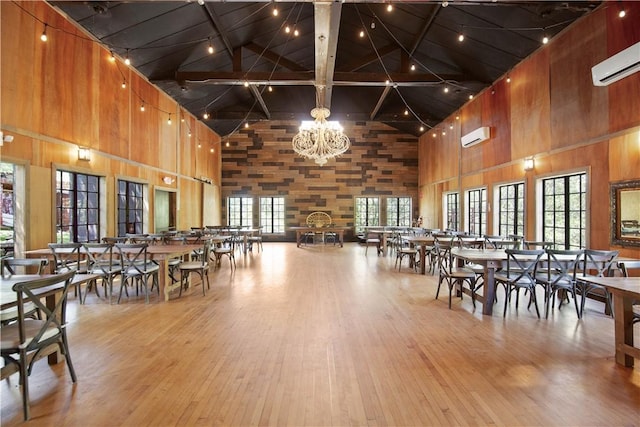 dining area with a wealth of natural light, wood-type flooring, and high vaulted ceiling