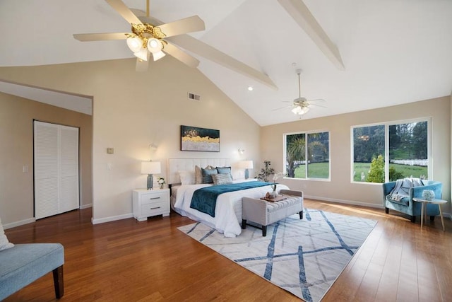 bedroom with ceiling fan, a closet, wood-type flooring, and lofted ceiling with beams