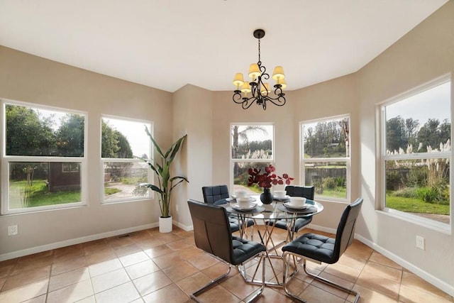 dining space with light tile patterned flooring and a chandelier