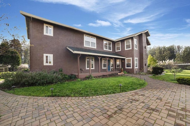 view of front of property with a porch and a front yard