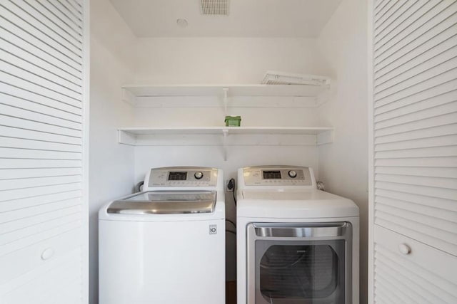 laundry room with washing machine and dryer