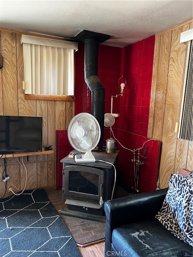 living room with a textured ceiling and a wood stove