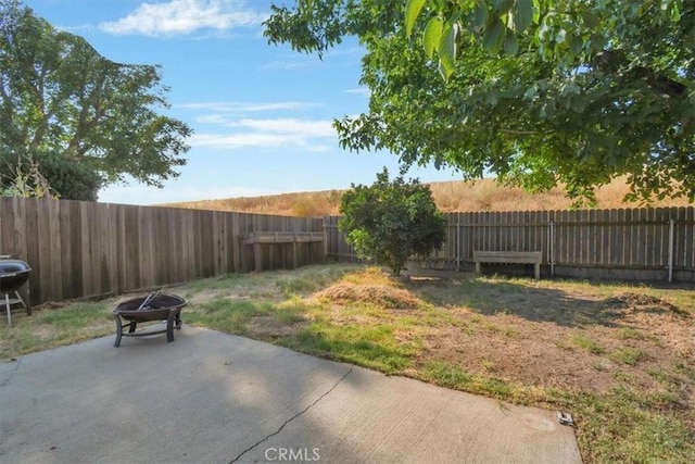 view of yard featuring a patio and a fire pit