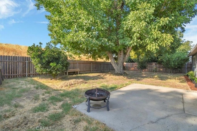 view of yard with a fire pit and a patio