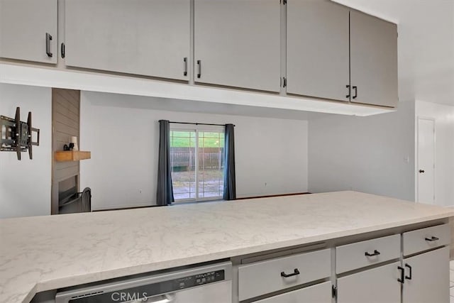 kitchen featuring stainless steel dishwasher and gray cabinets