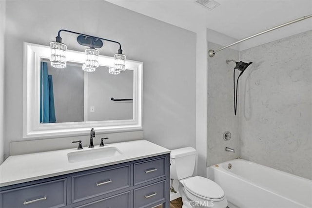 full bathroom with toilet, tiled shower / bath combo, and vanity