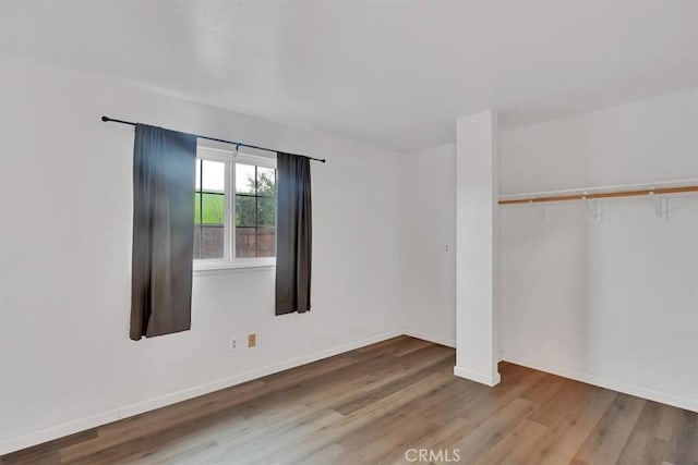 unfurnished room with hardwood / wood-style flooring