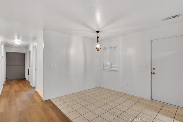 unfurnished room with light wood-type flooring