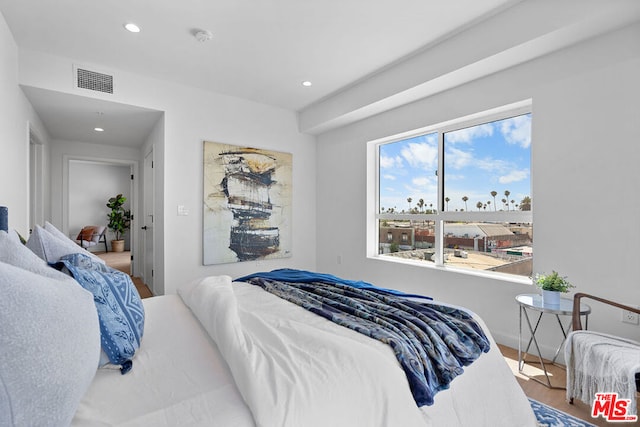 bedroom with hardwood / wood-style floors