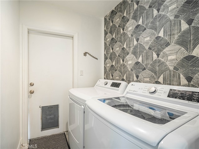 washroom featuring separate washer and dryer and tile walls