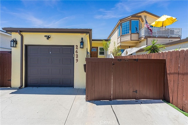 view of front of property with a balcony and a garage