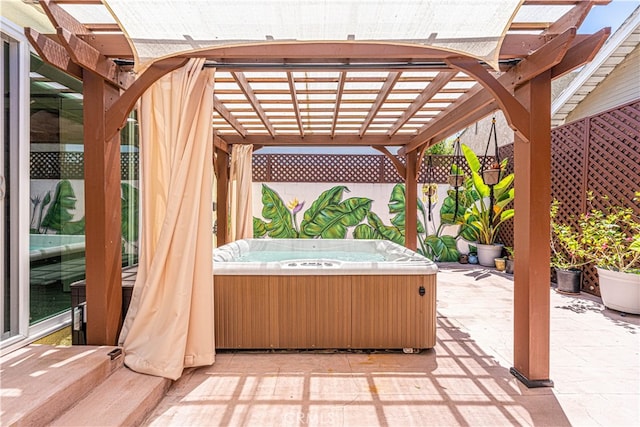 view of patio with a pergola and a hot tub