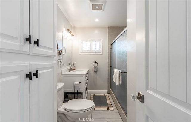 bathroom with walk in shower, vanity, and toilet