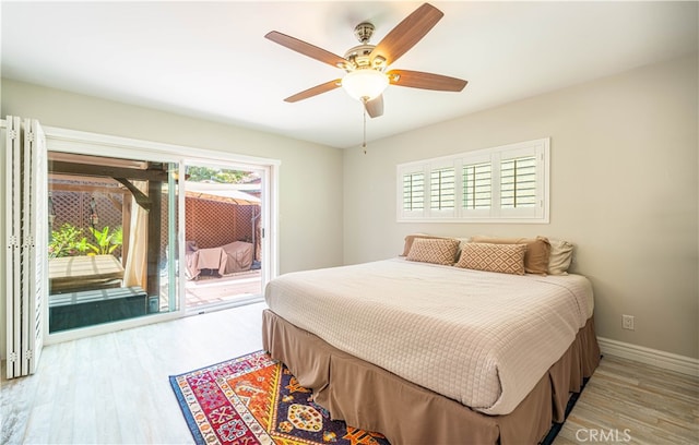 bedroom featuring light hardwood / wood-style floors, ceiling fan, and access to exterior