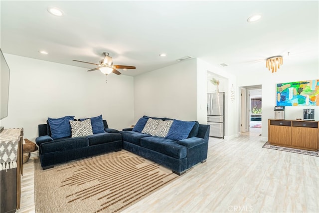 living room featuring light hardwood / wood-style floors and ceiling fan