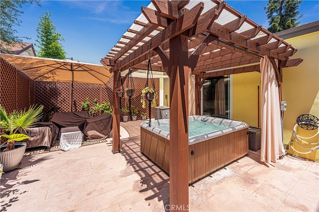 view of patio / terrace with a pergola and a hot tub