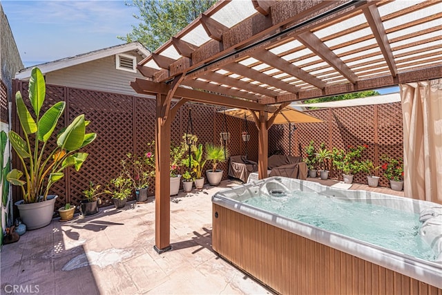 view of patio / terrace with a pergola and a hot tub