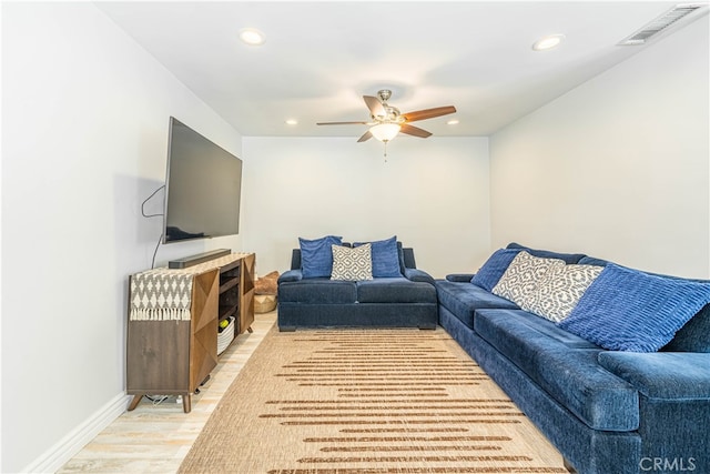 living room with light wood-type flooring and ceiling fan