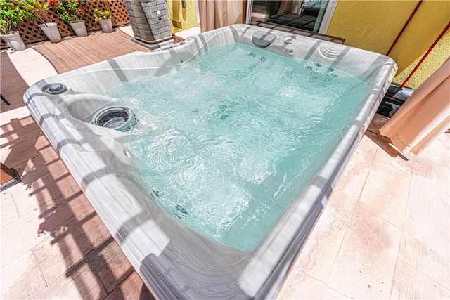 view of pool with a hot tub