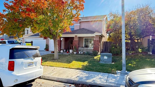 view of front of house featuring covered porch and a front yard