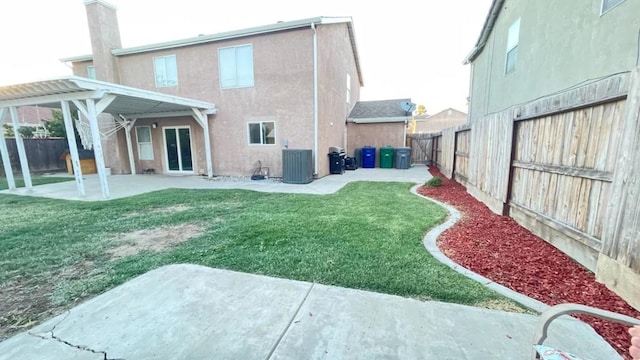 rear view of property featuring a lawn, a pergola, a patio area, and central air condition unit