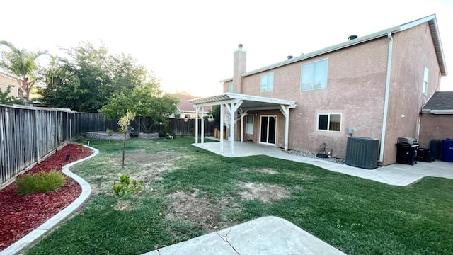 back of property with a yard, a patio, central AC, and a pergola