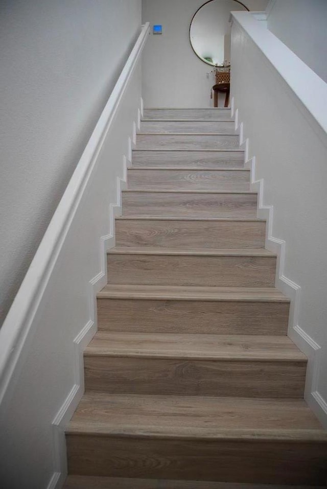 stairs featuring hardwood / wood-style flooring