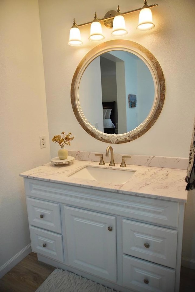 bathroom with hardwood / wood-style floors and vanity