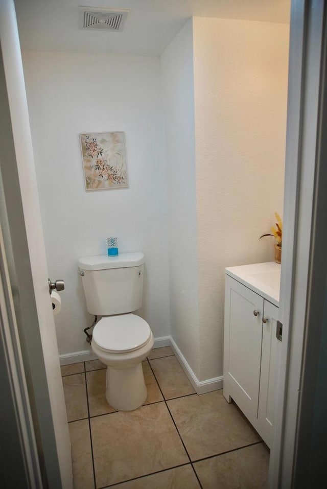 bathroom featuring tile patterned floors, vanity, and toilet