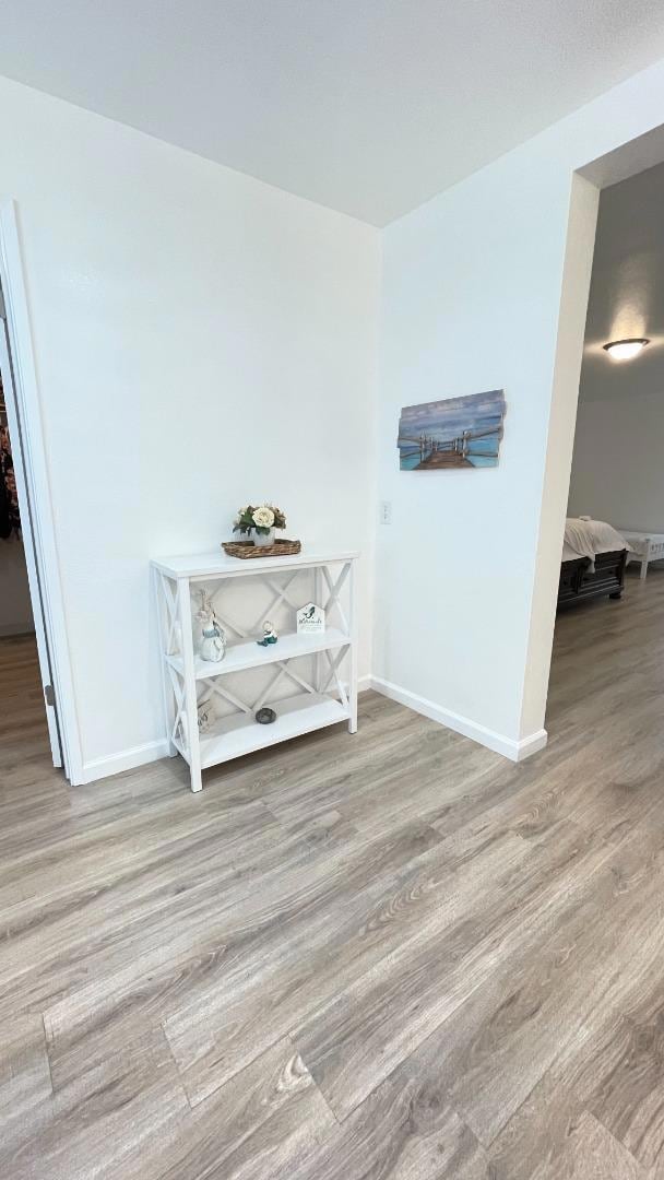 hallway with light hardwood / wood-style floors