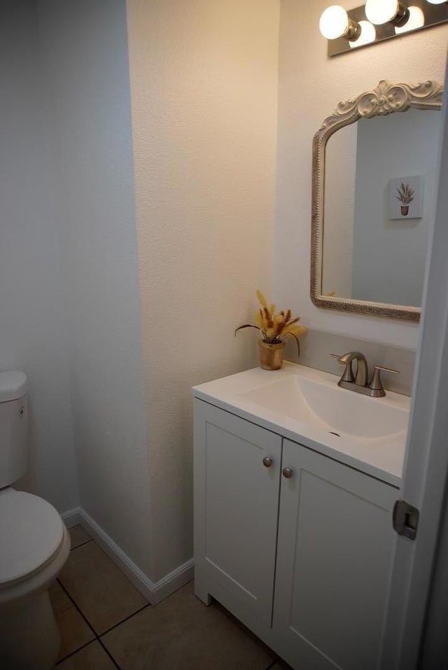 bathroom featuring tile patterned floors, vanity, and toilet