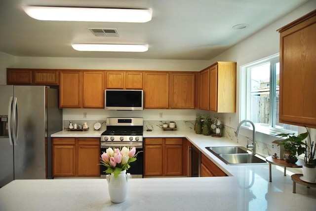 kitchen with sink and appliances with stainless steel finishes