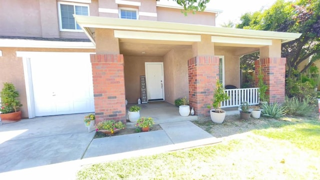 view of exterior entry with a garage and covered porch