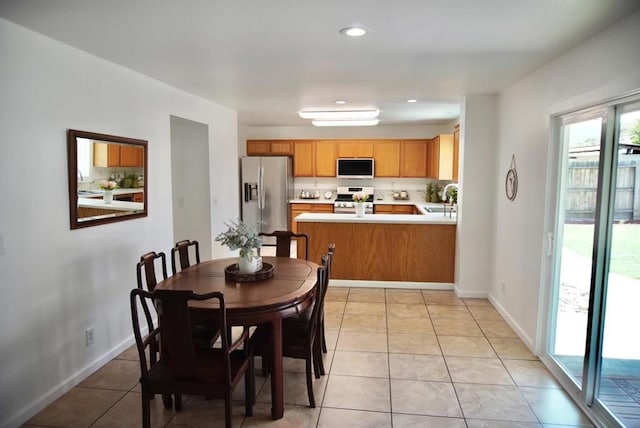 tiled dining space featuring sink