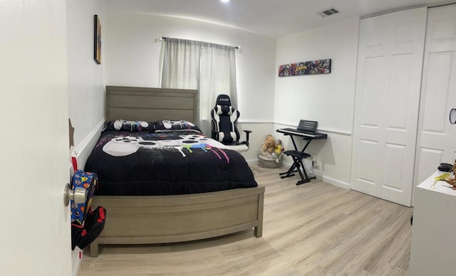 bedroom featuring light wood-type flooring and a closet