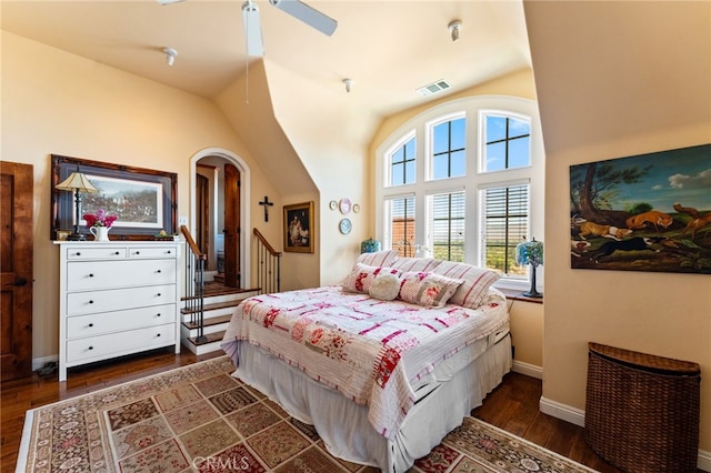 bedroom with ceiling fan, lofted ceiling, and dark hardwood / wood-style floors